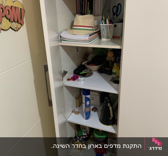 ארון פתוח עם מדפים, מכיל חפצים שונים